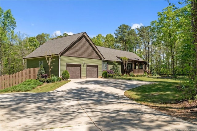 626 Bailey Rd, Coats, NC 27521 - view of front of home featuring driveway, covered porch, fence, a garage, and a front yard