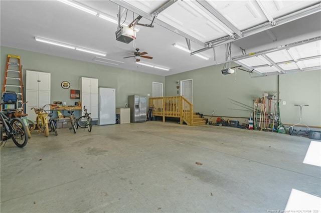 626 Bailey Rd, Coats, NC 27521 - garage featuring stainless steel refrigerator with ice dispenser, a garage door opener, and freestanding refrigerator