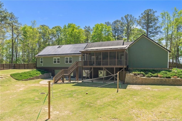 626 Bailey Rd, Coats, NC 27521 - rear view of house featuring a fenced backyard, a sunroom, stairway, and a lawn