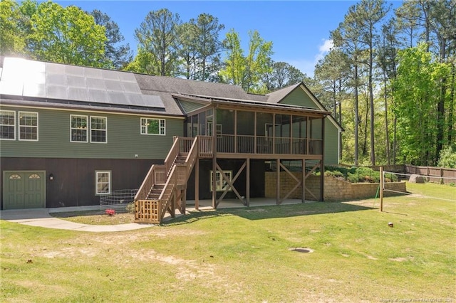 626 Bailey Rd, Coats, NC 27521 - back of property featuring solar panels, a shingled roof, stairway, a yard, and a sunroom