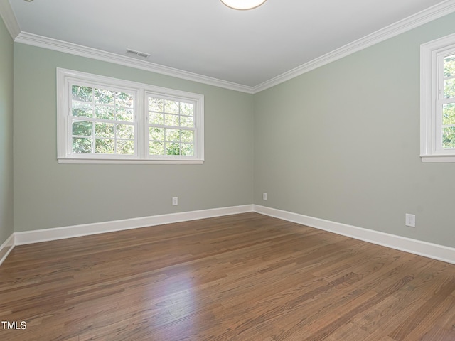 3009 Hillmer Dr, Raleigh, NC 27609 - unfurnished room with baseboards, visible vents, crown molding, and wood finished floors