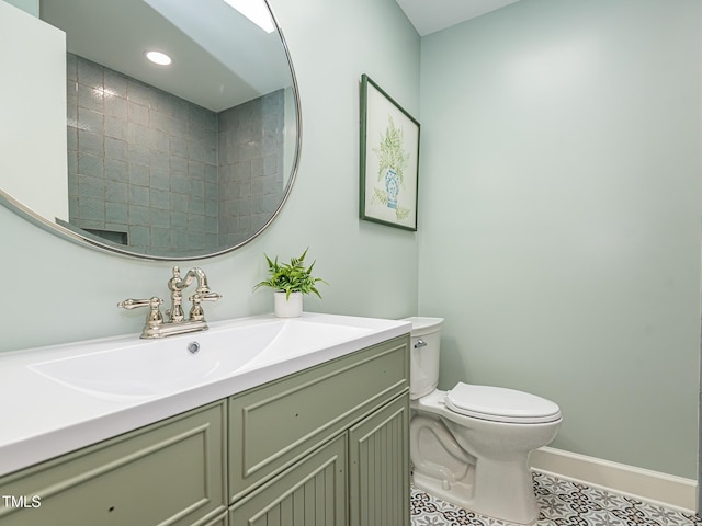 3009 Hillmer Dr, Raleigh, NC 27609 - bathroom featuring toilet, baseboards, tile patterned flooring, vanity, and recessed lighting