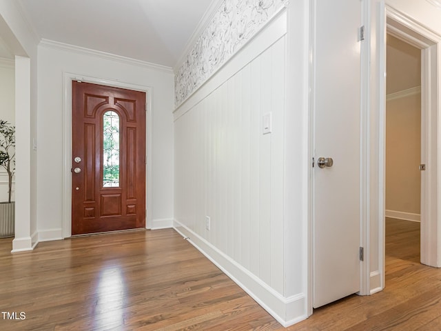 3009 Hillmer Dr, Raleigh, NC 27609 - entryway with wood finished floors, baseboards, and ornamental molding