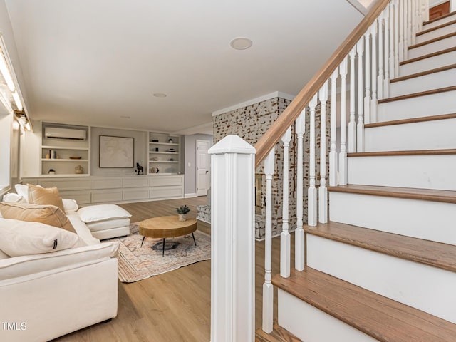 3009 Hillmer Dr, Raleigh, NC 27609 - living room with stairway, built in features, and wood finished floors
