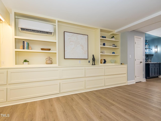 3009 Hillmer Dr, Raleigh, NC 27609 - interior space with wood finished floors, baseboards, a wall unit AC, and built in features