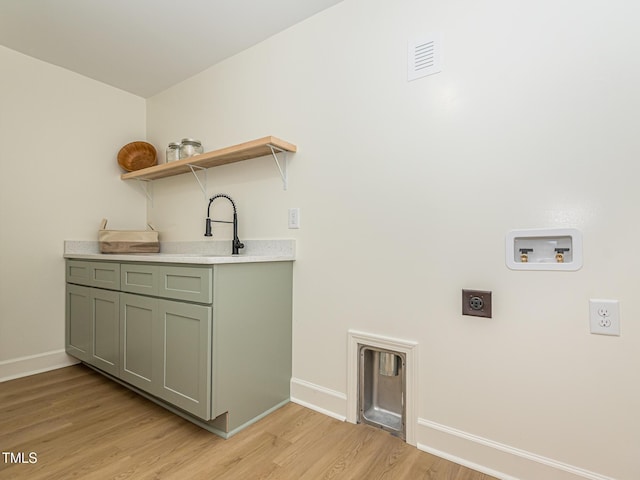 3009 Hillmer Dr, Raleigh, NC 27609 - washroom featuring baseboards, hookup for a washing machine, light wood-type flooring, and electric dryer hookup