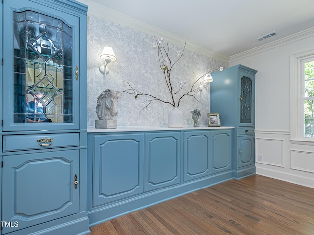 3009 Hillmer Dr, Raleigh, NC 27609 - entrance foyer featuring crown molding, visible vents, a wainscoted wall, and dark wood-type flooring