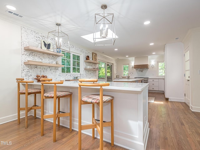 3009 Hillmer Dr, Raleigh, NC 27609 - kitchen featuring ornamental molding, a notable chandelier, and visible vents