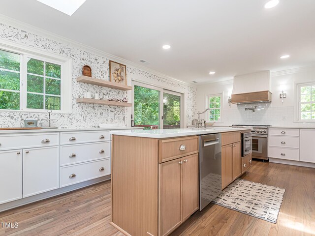 3009 Hillmer Dr, Raleigh, NC 27609 - kitchen with a sink, stainless steel appliances, ornamental molding, backsplash, and light countertops
