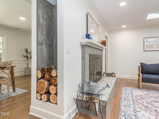 3009 Hillmer Dr, Raleigh, NC 27609 - living area featuring crown molding, wood finished floors, and recessed lighting