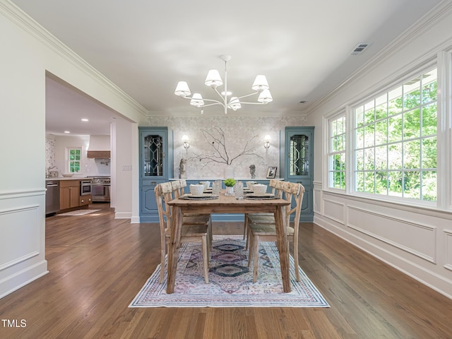 3009 Hillmer Dr, Raleigh, NC 27609 - dining area featuring a decorative wall, ornamental molding, visible vents, dark wood-style flooring, and a notable chandelier