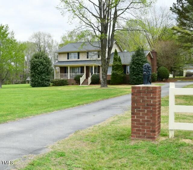 775 Sid Eaves Rd, Youngsville, NC 27596 - view of front facade featuring a porch, driveway, and a front lawn