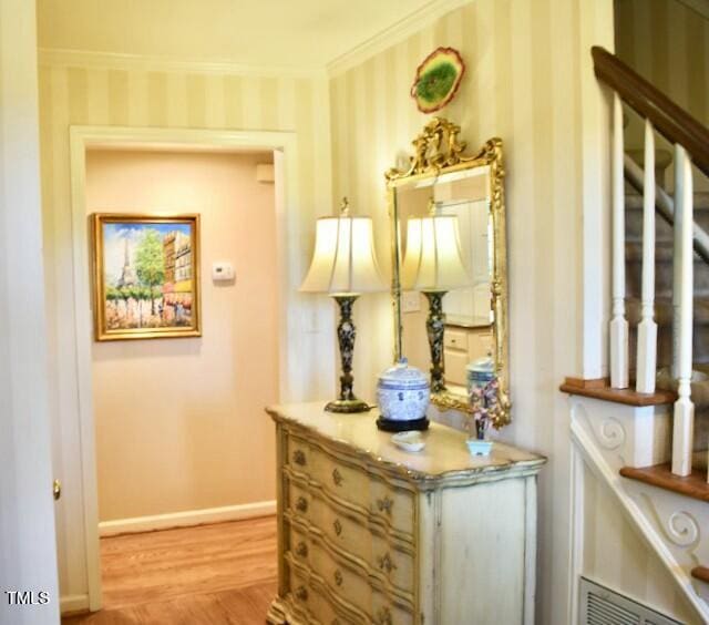 775 Sid Eaves Rd, Youngsville, NC 27596 - hall featuring wallpapered walls, light wood-type flooring, crown molding, and baseboards