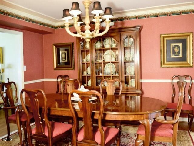 775 Sid Eaves Rd, Youngsville, NC 27596 - dining room with a chandelier, wood finished floors, and crown molding