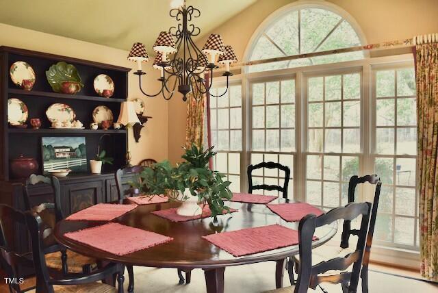 775 Sid Eaves Rd, Youngsville, NC 27596 - dining space with vaulted ceiling, a wealth of natural light, and a chandelier