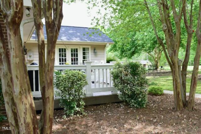 775 Sid Eaves Rd, Youngsville, NC 27596 - rear view of property featuring a wooden deck and roof with shingles