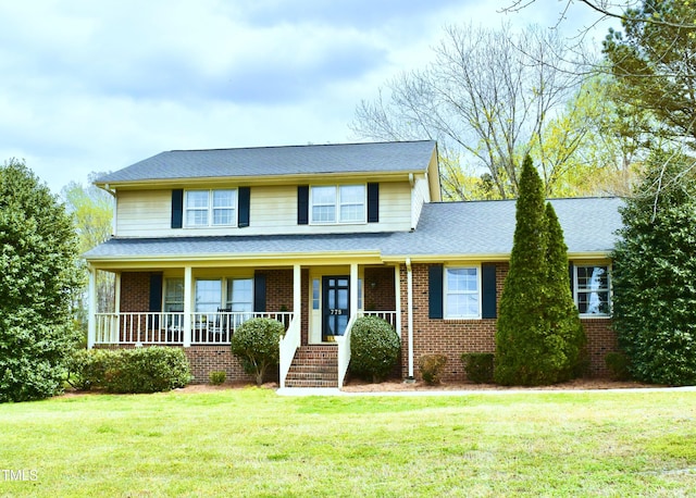 775 Sid Eaves Rd, Youngsville, NC 27596 - traditional-style home featuring a front yard, a shingled roof, covered porch, and brick siding