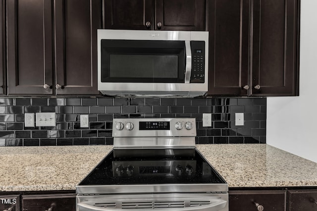 kitchen featuring backsplash, dark brown cabinetry, and stainless steel appliances