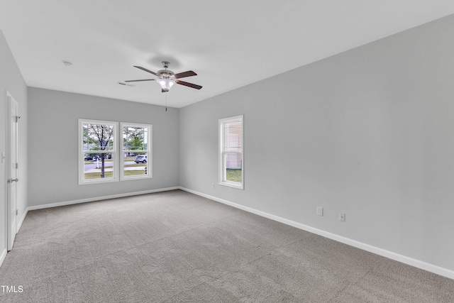 unfurnished room featuring carpet flooring, a ceiling fan, and baseboards