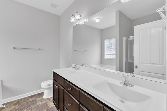 full bath featuring a sink, baseboards, a stall shower, and toilet