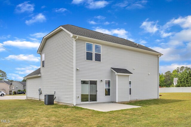 back of house with a yard, cooling unit, and a patio area