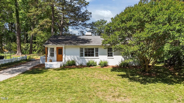 207 N Aiken St, Fuquay Varina, NC 27526 - view of front facade with brick siding, a chimney, fence, and a front yard