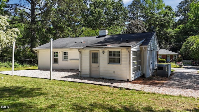 207 N Aiken St, Fuquay Varina, NC 27526 - back of property featuring a chimney and a yard