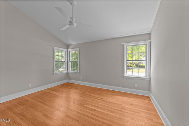 207 N Aiken St, Fuquay Varina, NC 27526 - unfurnished room featuring a ceiling fan, light wood-type flooring, lofted ceiling, and a wealth of natural light
