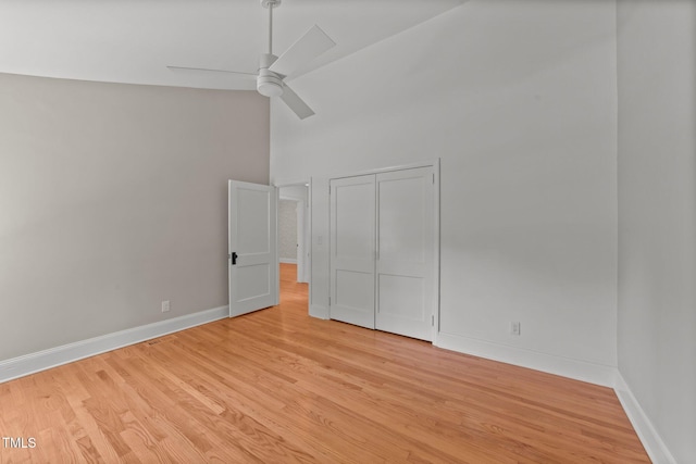207 N Aiken St, Fuquay Varina, NC 27526 - unfurnished bedroom with a high ceiling, ceiling fan, baseboards, and light wood-style floors
