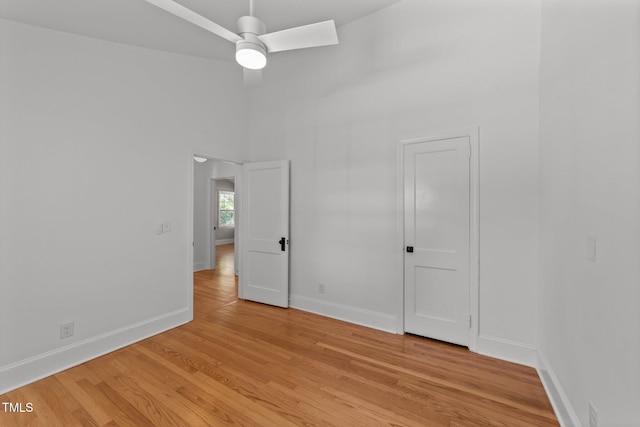 207 N Aiken St, Fuquay Varina, NC 27526 - empty room with a ceiling fan, baseboards, a high ceiling, and light wood-type flooring