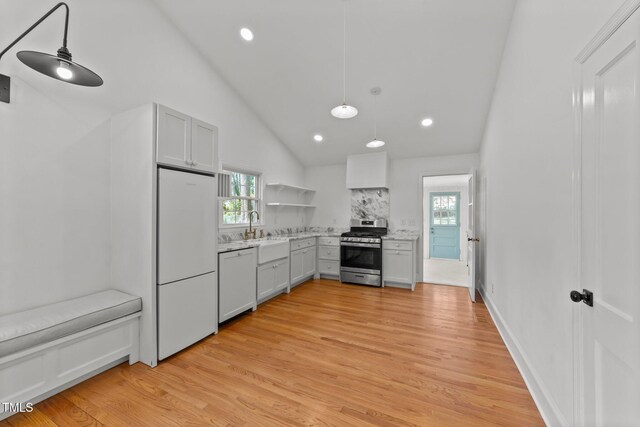 207 N Aiken St, Fuquay Varina, NC 27526 - kitchen featuring open shelves, refrigerator, stainless steel range with gas stovetop, light wood-style flooring, and dishwasher