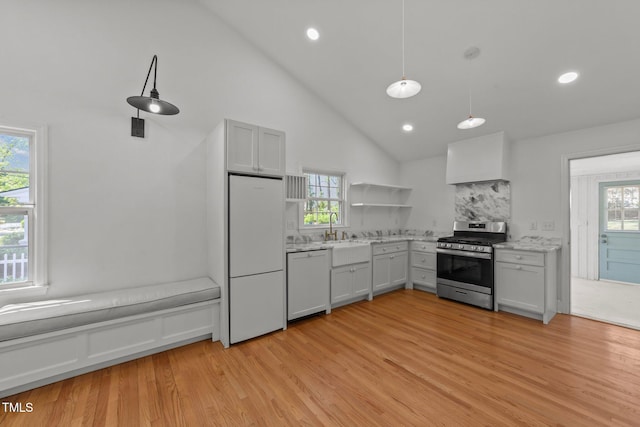 207 N Aiken St, Fuquay Varina, NC 27526 - kitchen featuring gas range, open shelves, white fridge, paneled dishwasher, and light wood-style flooring