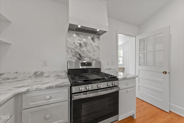 207 N Aiken St, Fuquay Varina, NC 27526 - kitchen featuring gas stove, white cabinets, light stone countertops, and light wood finished floors
