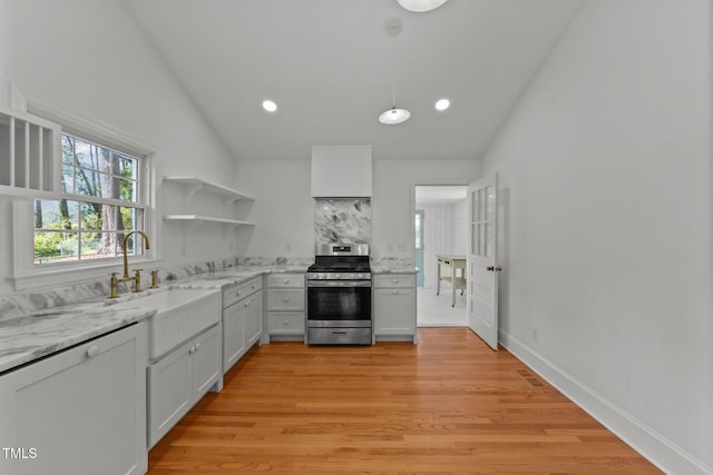 207 N Aiken St, Fuquay Varina, NC 27526 - kitchen with open shelves, stainless steel range with gas cooktop, recessed lighting, a sink, and vaulted ceiling