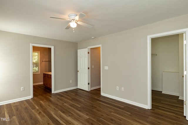 518 S Coalport Dr, Apex, NC 27502 - unfurnished bedroom featuring a spacious closet, dark wood-type flooring, baseboards, and a closet