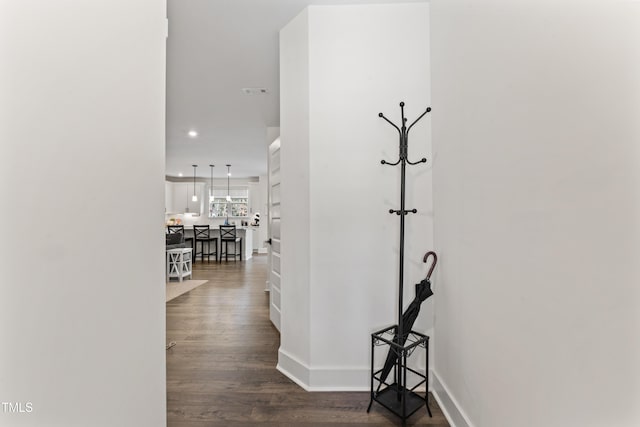 hall with recessed lighting, dark wood-style floors, and baseboards