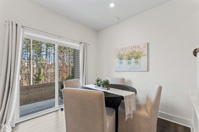 dining area with wood finished floors, baseboards, and recessed lighting