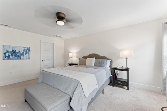 bedroom with light colored carpet, baseboards, and a ceiling fan