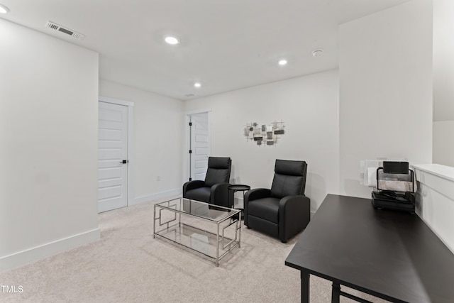 living room with recessed lighting, light colored carpet, and baseboards