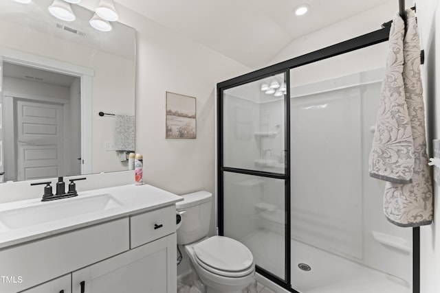 bathroom featuring a shower stall, toilet, vanity, and vaulted ceiling
