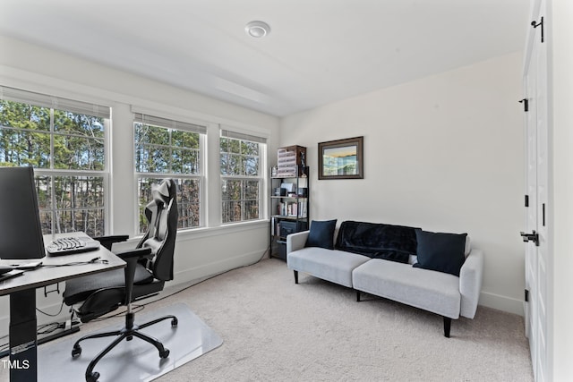 carpeted office featuring baseboards