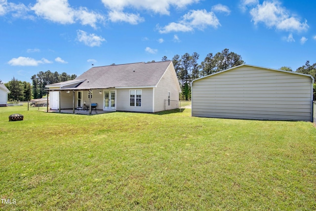rear view of property featuring a patio, a fire pit, and french doors