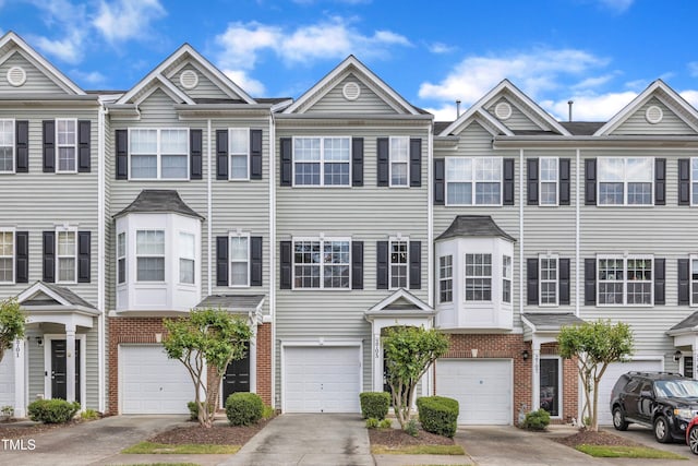 2705 Wyntercrest Ln, Durham, NC 27713 - view of property with brick siding, an attached garage, and driveway