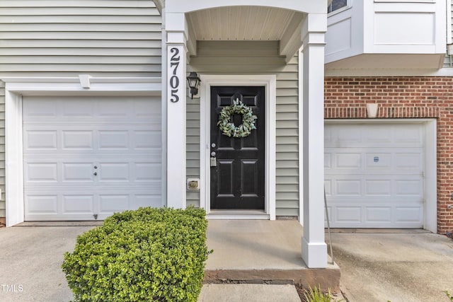 2705 Wyntercrest Ln, Durham, NC 27713 - property entrance with brick siding, driveway, and a garage