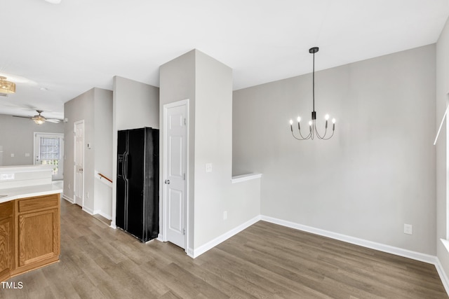 2705 Wyntercrest Ln, Durham, NC 27713 - interior space with brown cabinets, wood finished floors, light countertops, baseboards, and black fridge