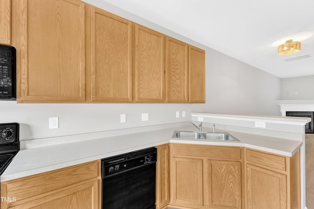 2705 Wyntercrest Ln, Durham, NC 27713 - kitchen with a sink, a peninsula, black appliances, and light brown cabinets