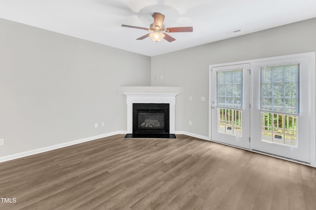 2705 Wyntercrest Ln, Durham, NC 27713 - unfurnished living room featuring baseboards, a ceiling fan, a fireplace with flush hearth, and wood finished floors