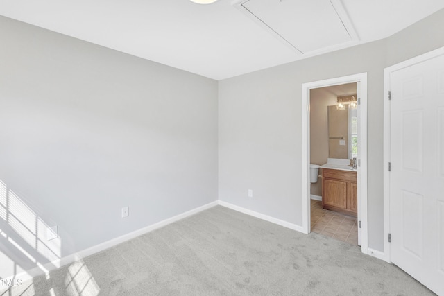 2705 Wyntercrest Ln, Durham, NC 27713 - unfurnished bedroom with connected bathroom, light carpet, a sink, attic access, and baseboards