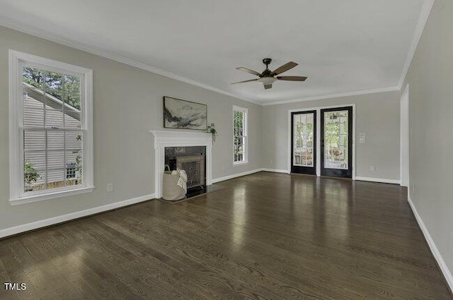 unfurnished living room featuring crown molding, a high end fireplace, ceiling fan, and a wealth of natural light