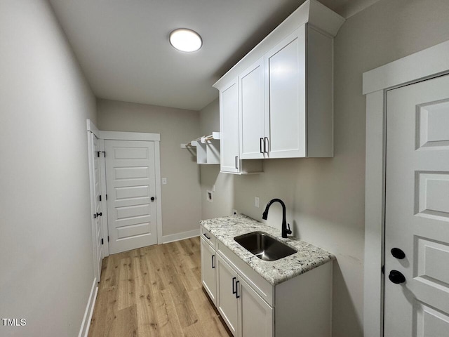 27 Batten Hill Ln, Selma, NC 27576 - laundry area with cabinet space, light wood-style floors, hookup for a washing machine, and electric dryer hookup